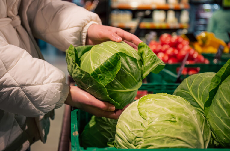 a-woman-chooses-cabbage-in-a-grocery-store-closeup.jpg